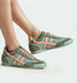 Stylish sneakers in green and peach, featuring mesh design, perfect for casual wear or active lifestyle.